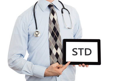 Physician holding a sign with the words STD