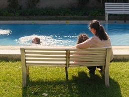 Woman supervising child in swimming pool.